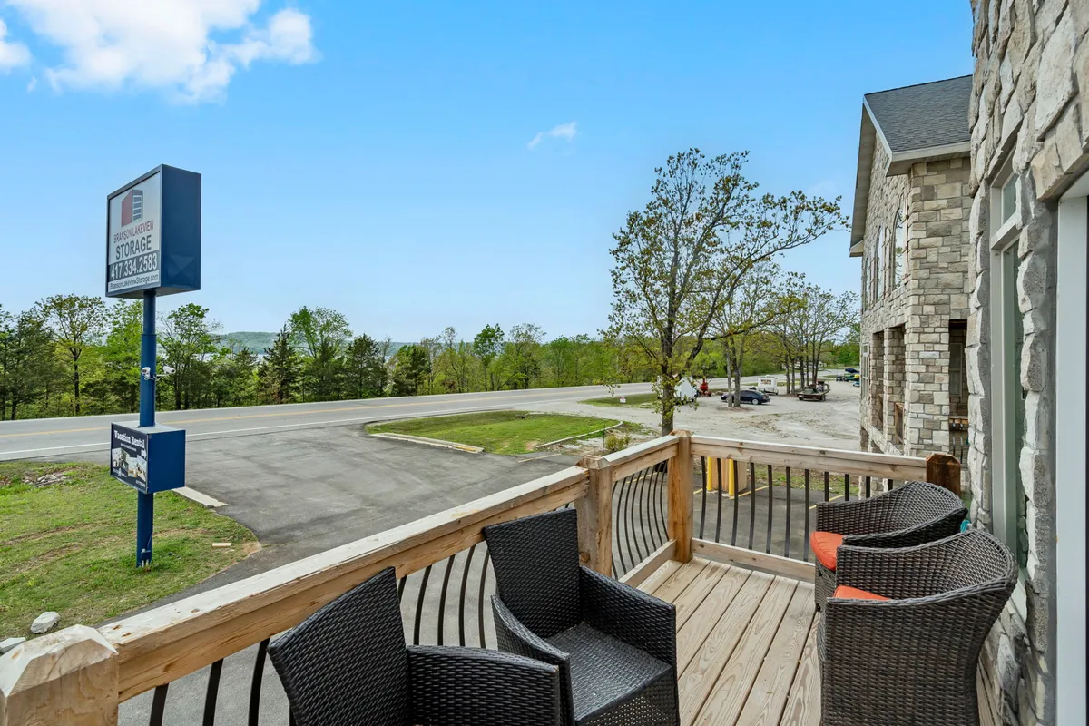A welcoming deck with outdoor seating overlooking a road and nearby signage, offering a place to step outside and soak in the atmosphere, with a direct connection to local energy.